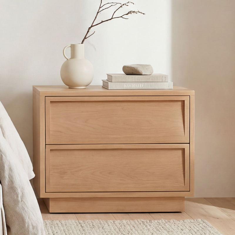 Natural wood two-drawer nightstand with wide top and recessed drawer panels