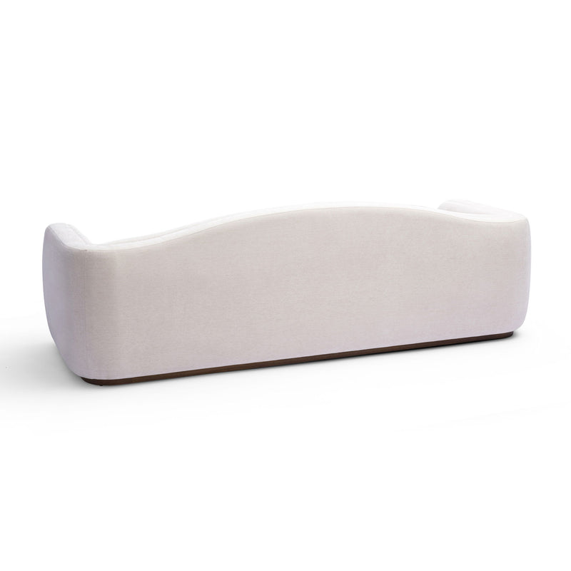 White low-profile sofa with rounded side arms and tufted seat