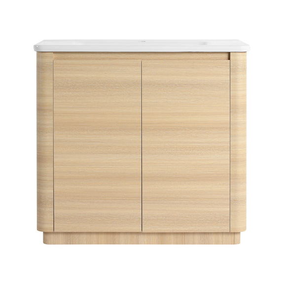 Freestanding bathroom vanity with white sink top and light brown two-door cabinet