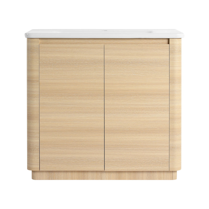 Freestanding bathroom vanity with white sink top and light brown two-door cabinet