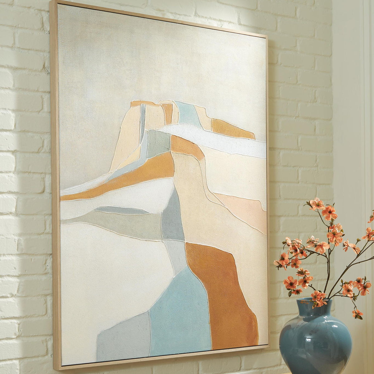 Framed abstract wall art with blue and orange geometric shapes