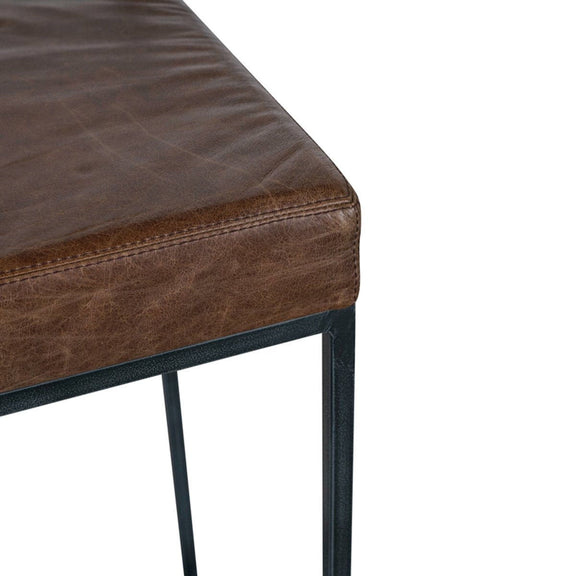 Dark brown upholstered counter stool seat cushion with stitched edge and frame