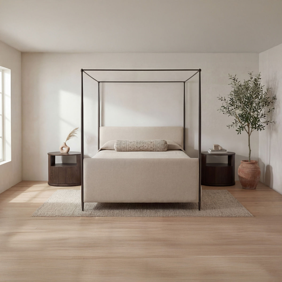 Beige king bed with black metal canopy frame, platform base, and pillow