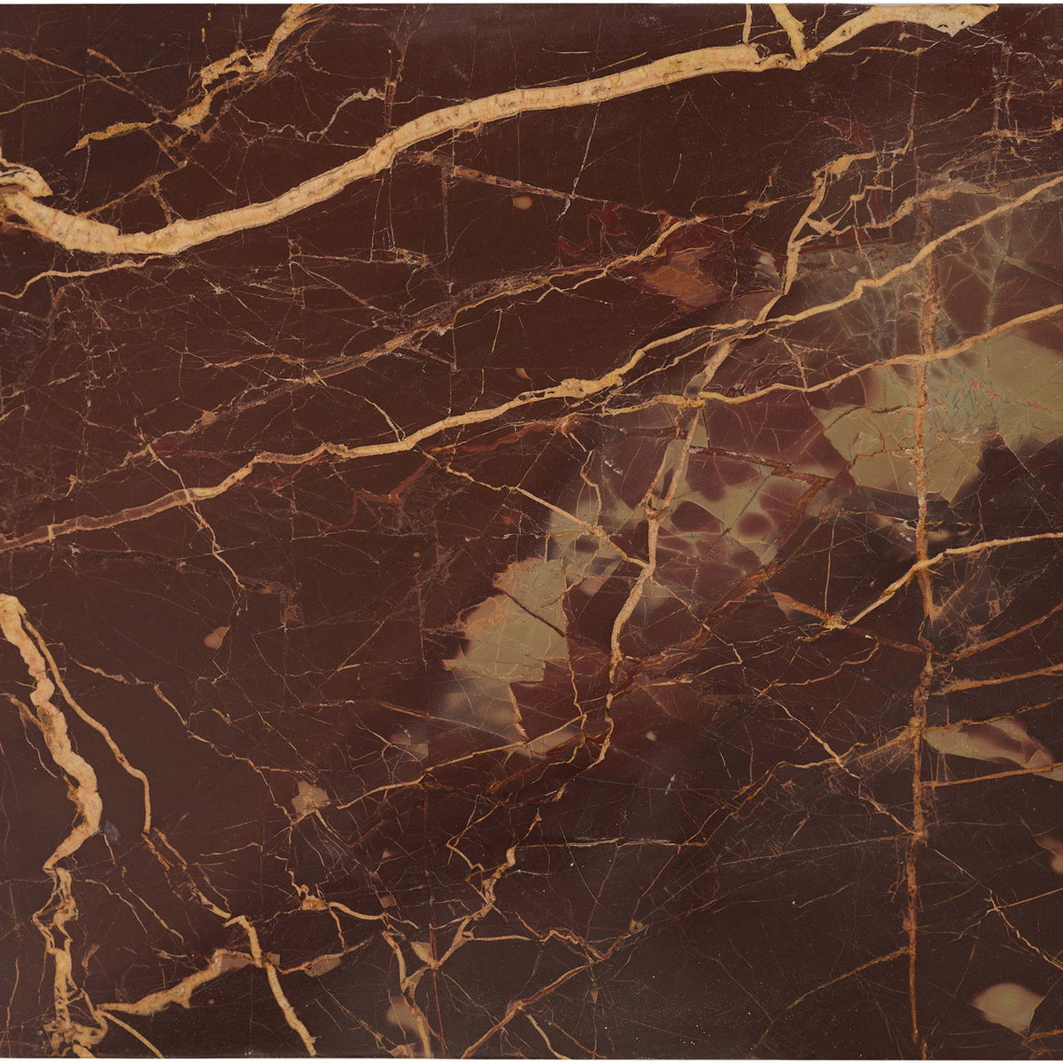 Dark red marble serving tray with brass corner handles and dramatic veining.