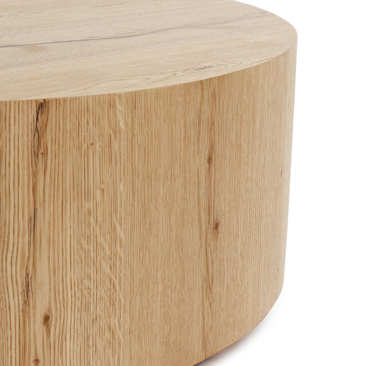 Round coffee table with natural light wood grain finish and curved side