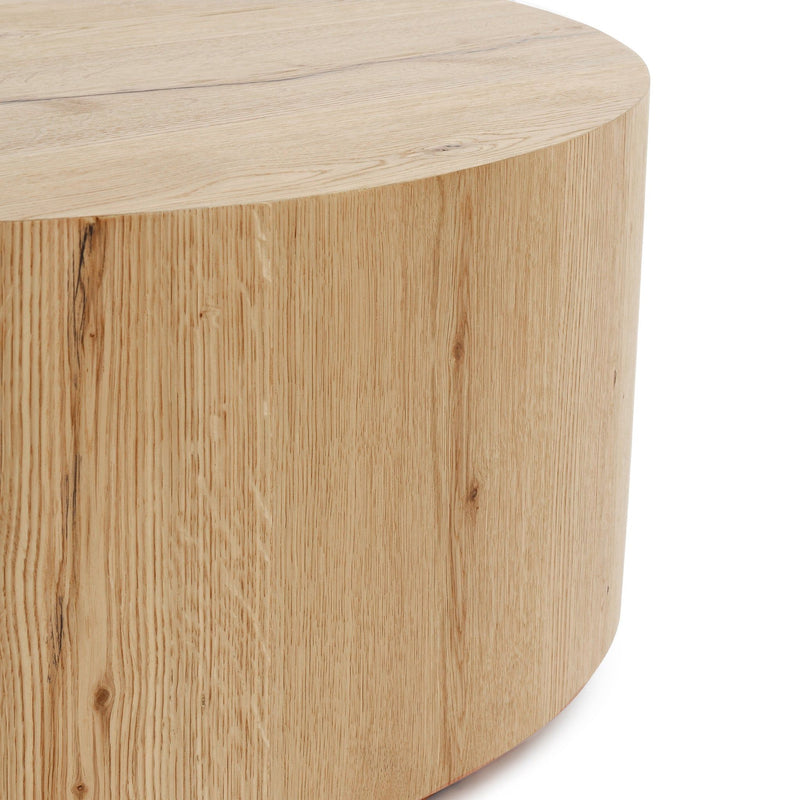 Round coffee table with natural light wood grain finish and curved side