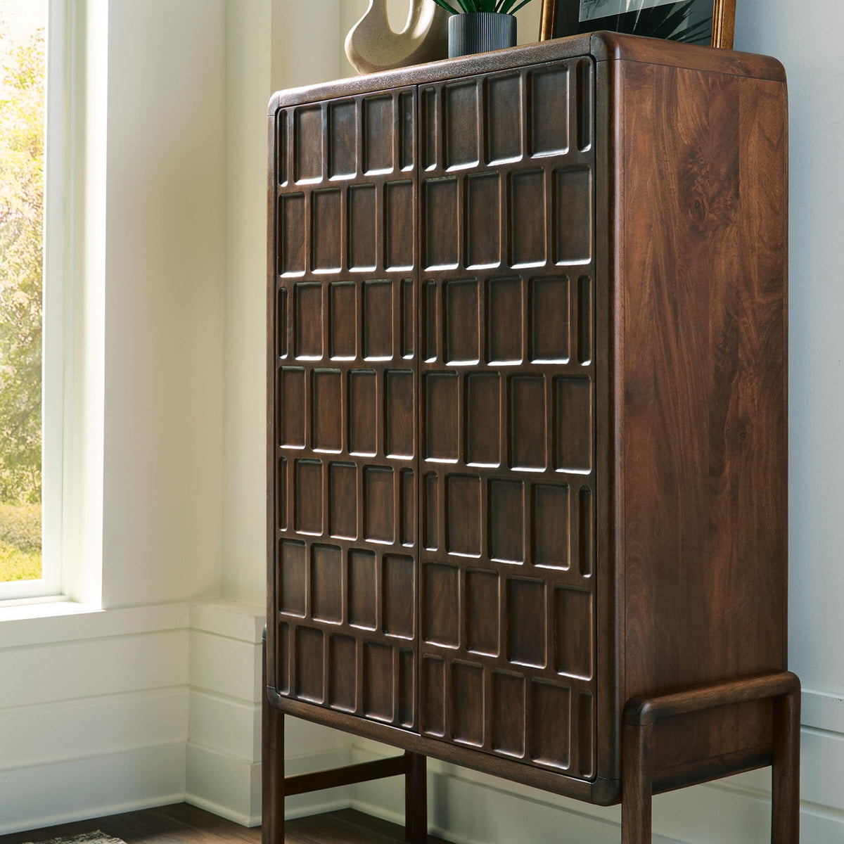 Brown accent cabinet with geometric square-panel door and angled side