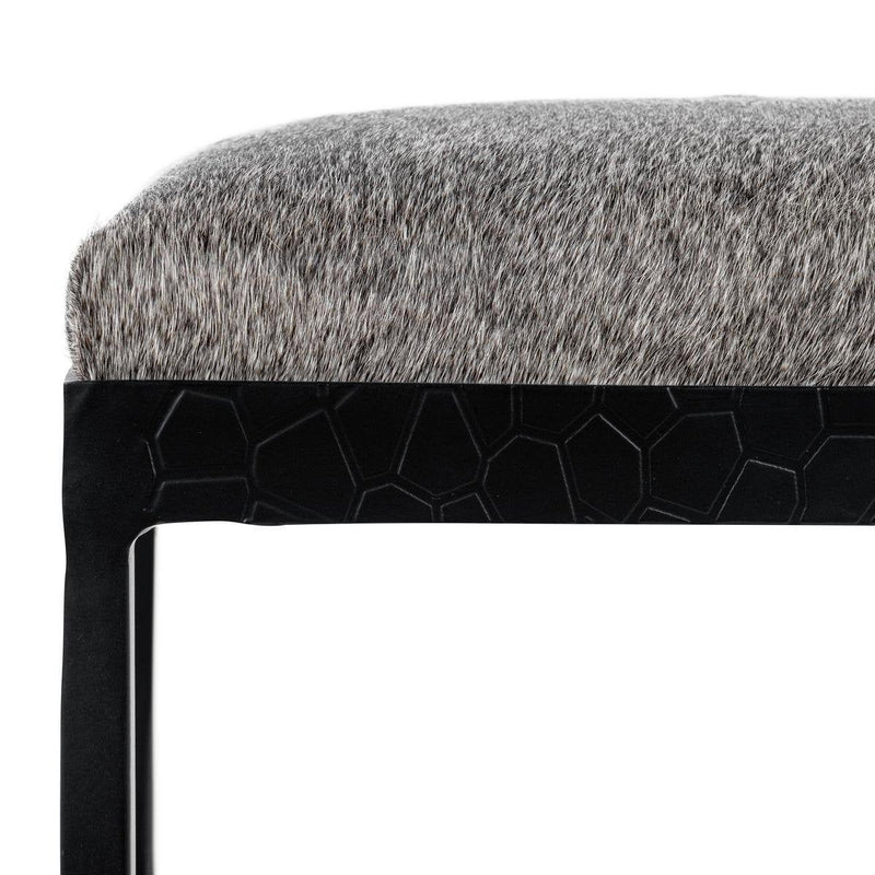 Gray upholstered stool seat with dark honeycomb-style side panel