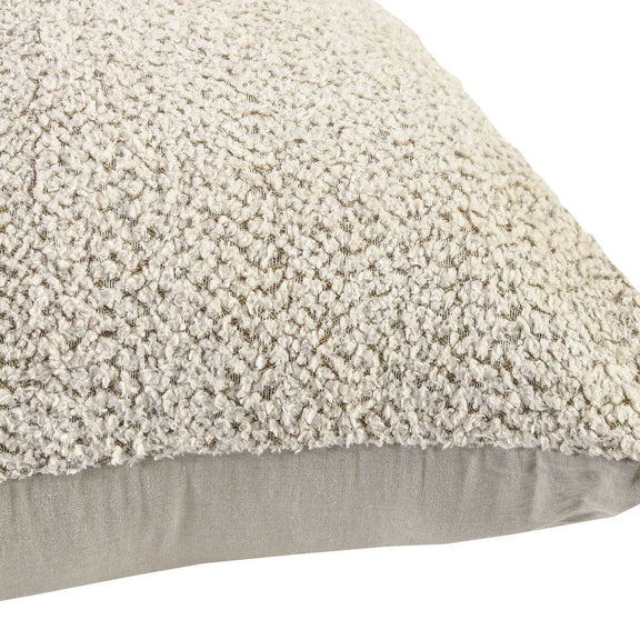Close-up of beige textured floor cushion fabric with smooth gray side panel