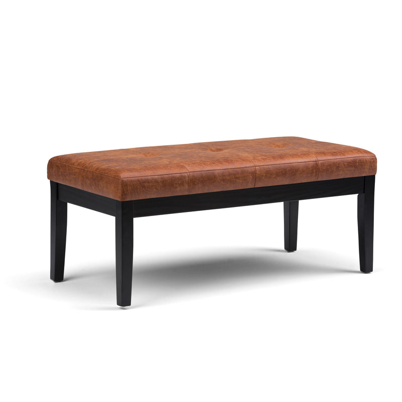 Light brown upholstered tufted ottoman bench with stitched padded top and tapered legs