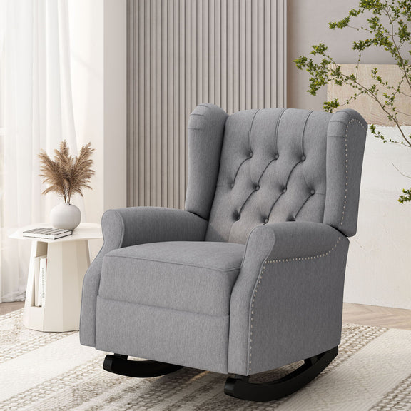 Gray tufted wingback rocker with nailhead trim and black curved rockers, shown at an angle