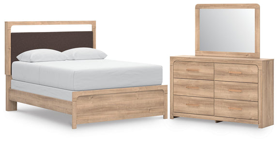 Queen upholstered panel bed with tan dresser and arched mirror set