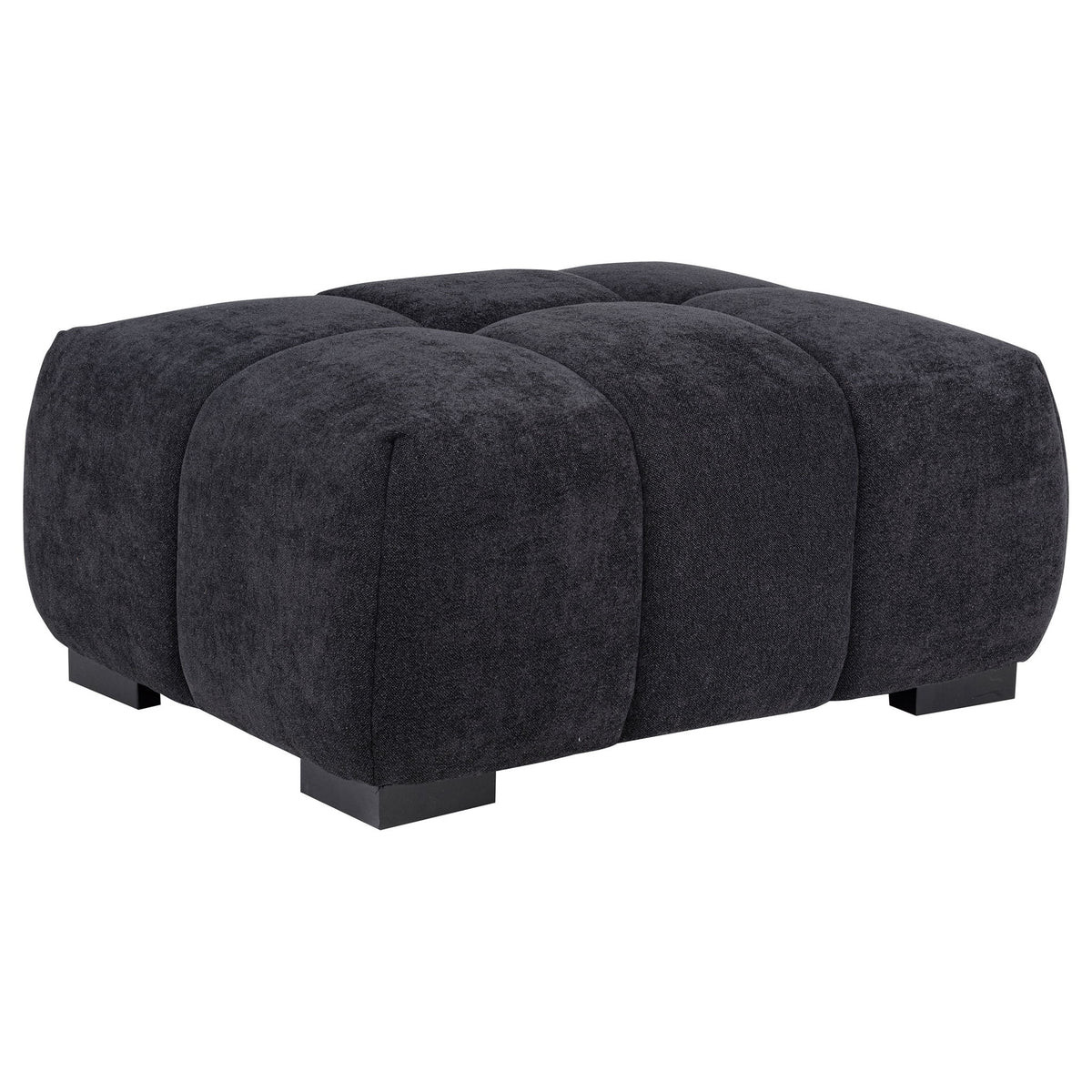 Dark gray rectangular upholstered ottoman with tufted sections and low black legs.