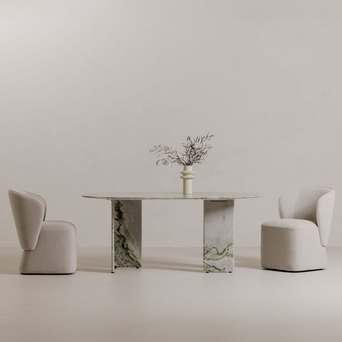 Oval marble dining table with green veined center pedestals and matching top