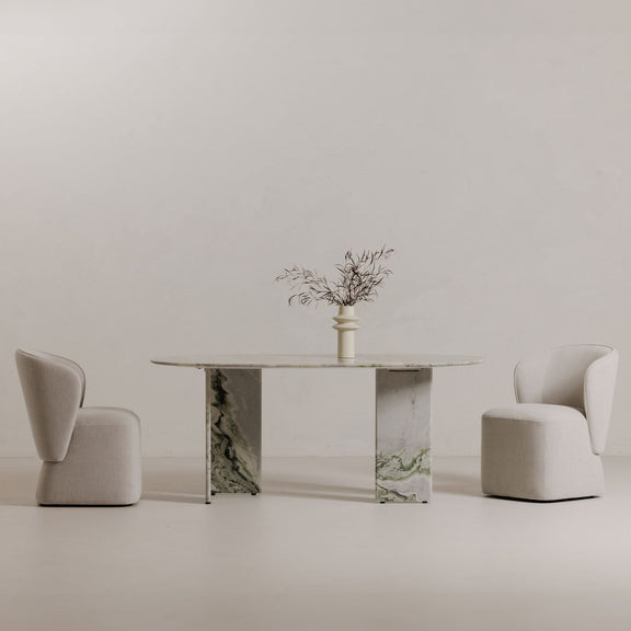 Oval marble dining table with green veined center pedestals and matching top