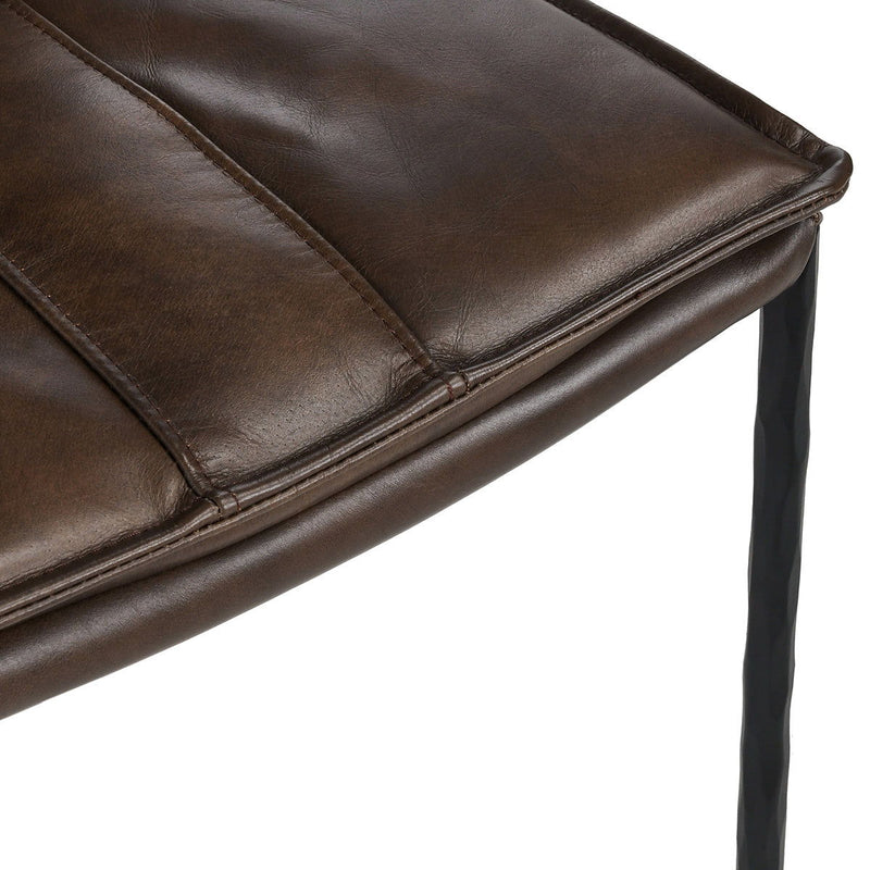 Brown leather-look bar stool seat corner detail with stitched edge and metal frame