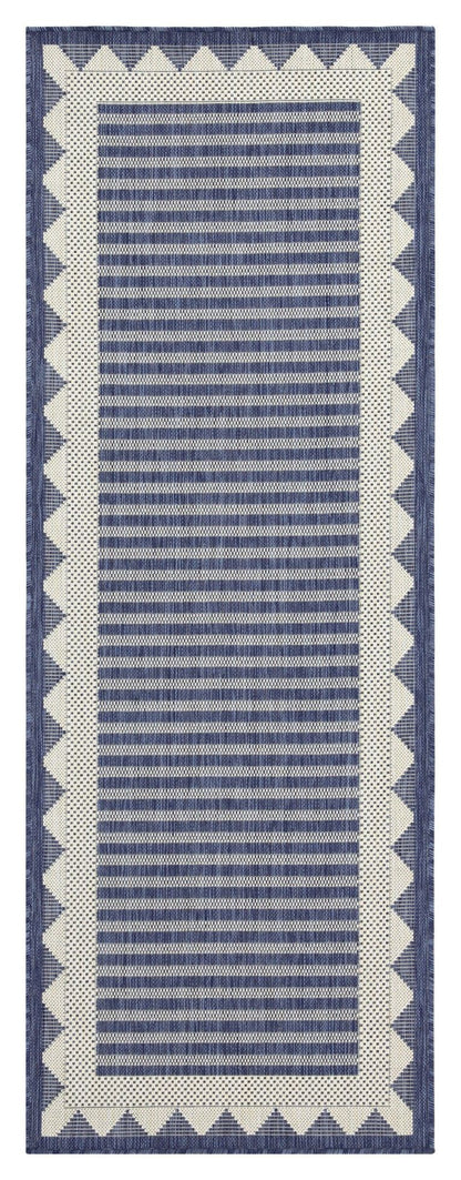 Navy blue area rug with vertical striped pattern and cream zigzag border