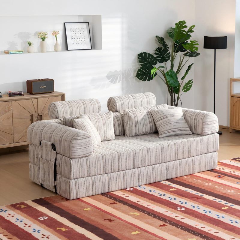 Sleeper sofa bed converted with backrests folded down, striped cushions and arms