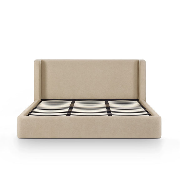 Beige chenille bed with tall headboard and striped duvet across the mattress
