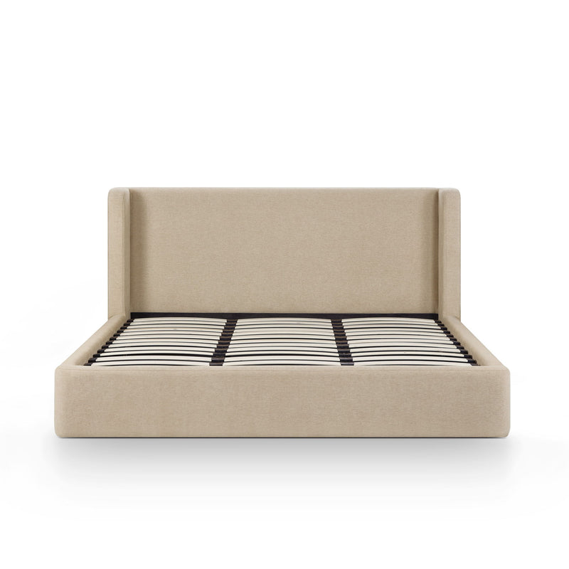 Beige chenille bed with tall headboard and striped duvet across the mattress