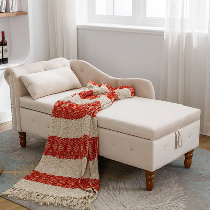 Beige upholstered chaise lounge with rolled arms, nailhead trim, side storage, pillow.