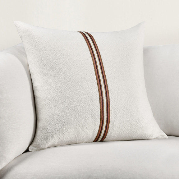 Ivory pillow detail with vertical striped trim in brown and red