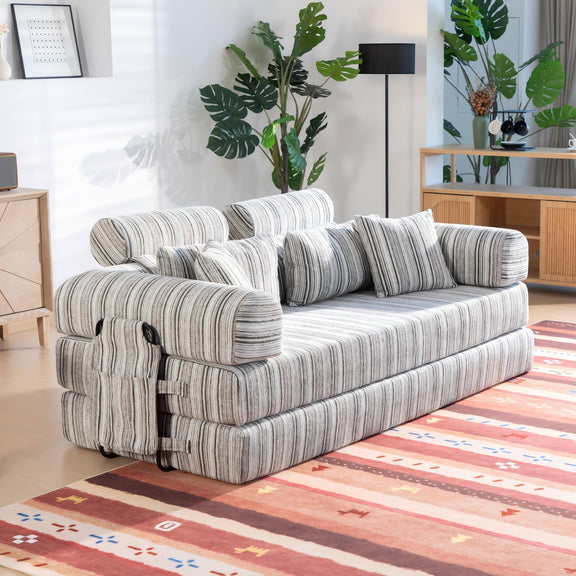 Convertible sofa bed in sleeper position with striped upholstery and side armrest details