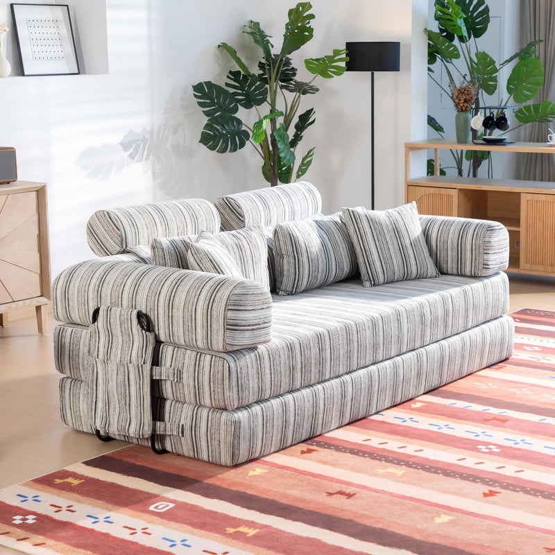 Convertible sofa bed in sleeper position with striped upholstery and side armrest details