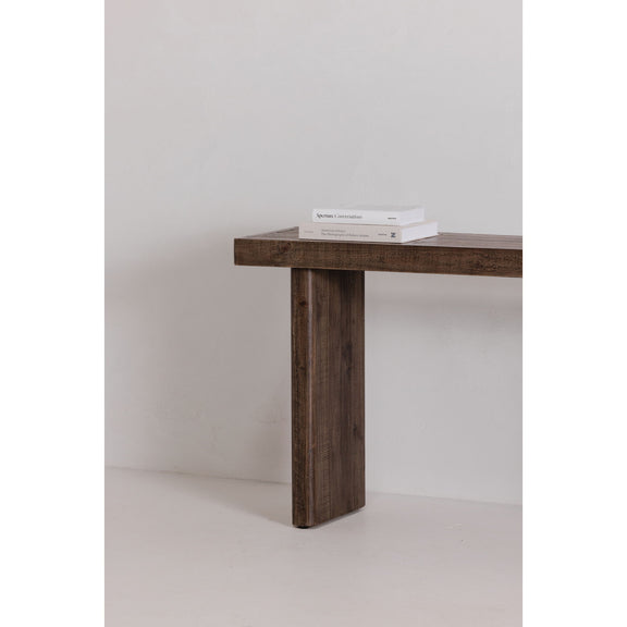 Aged brown console table corner view with textured wood top and tapered leg