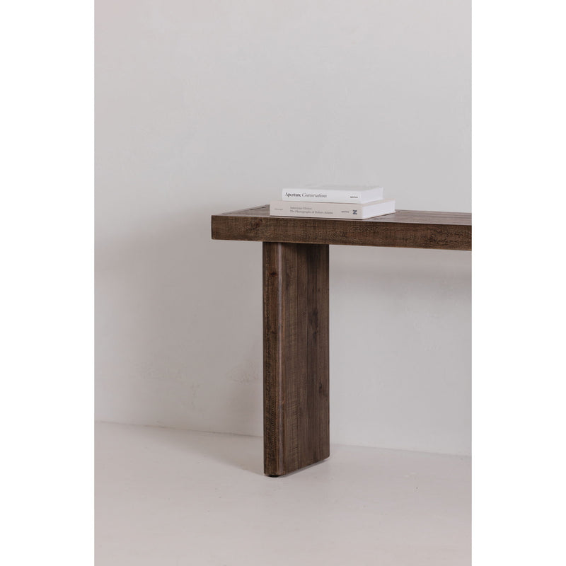 Aged brown console table corner view with textured wood top and tapered leg