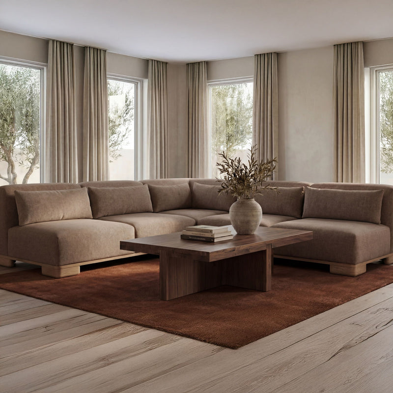 L-shaped sectional sofa with brown fabric upholstery and cushioned backrests
