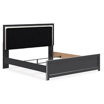 Upholstered panel headboard with dark ribbed fabric and bed frame rails, side view