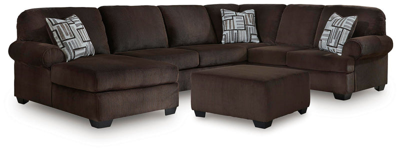 Dark brown sectional sofa with corner chaise, ottoman and two patterned throw pillows