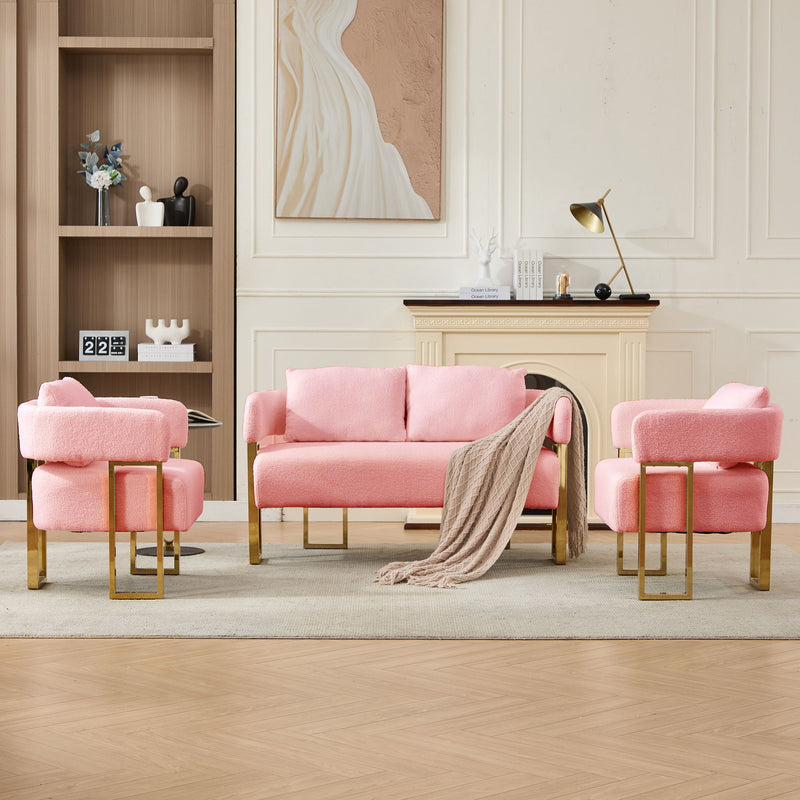 Pink upholstered side chair with plush seat, rounded arms, and gold-toned wood legs