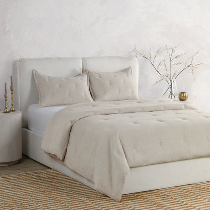 Light natural comforter set with matching pillow shams and folded comforter
