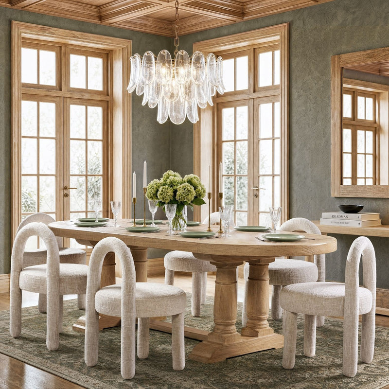 Beige fully upholstered dining side chairs with round-arched frames and curved arms