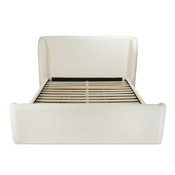 Cream king bed frame with slatted base visible behind the headboard
