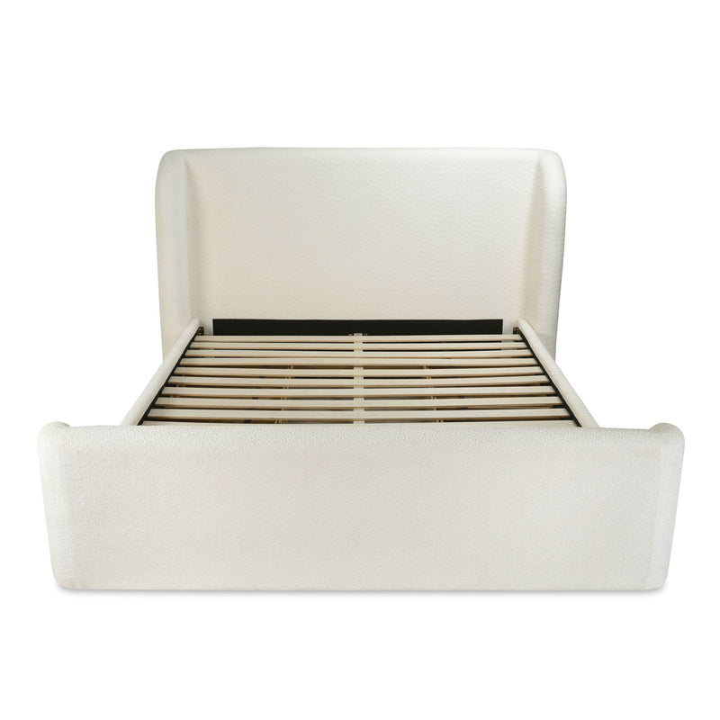 Cream king bed frame with slatted base visible behind the headboard