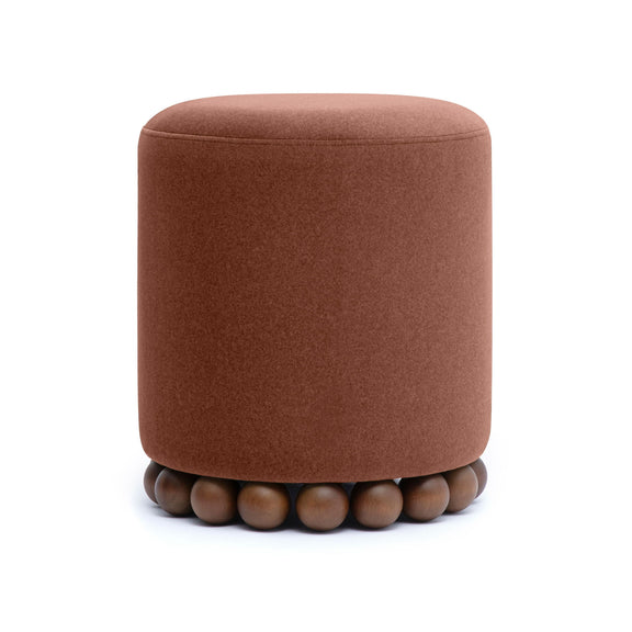 Round upholstered ottoman in rust brown with beaded wooden base