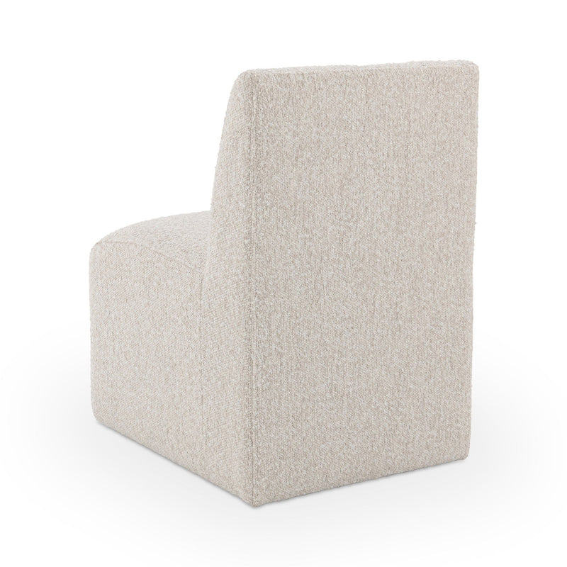 Upholstered dining chair in light beige fabric, three-quarter view of seat and back