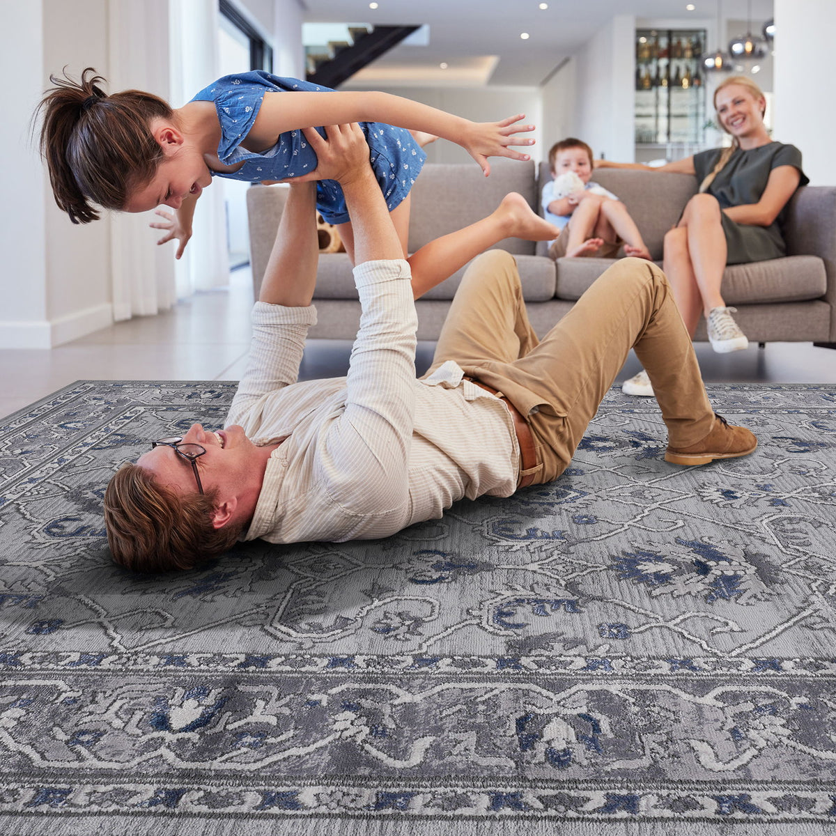 Gray and blue oriental rug surface detail with decorative center pattern and border.