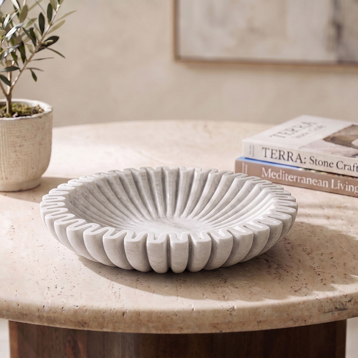 Decorative shallow bowl with concentric ridges, light gray finish on surface.