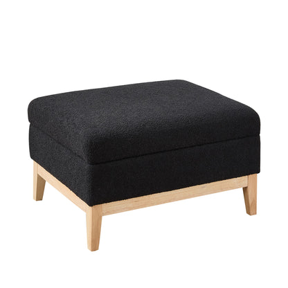 Black upholstered storage ottoman with reversible lid and light wood legs.