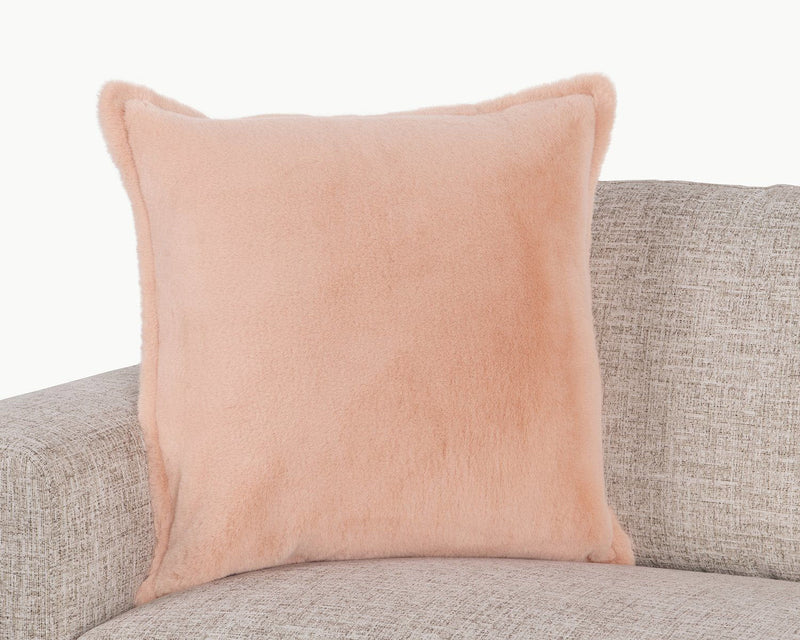 Peach plush throw pillow with piped edges and rounded corners