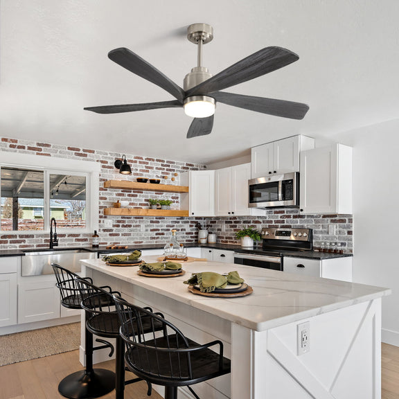 Nickel ceiling fan with five dark gray blades and round LED light in a kitchen.