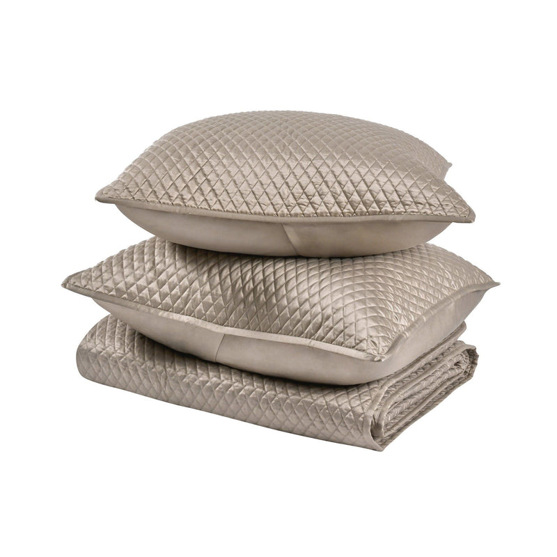 Stacked beige diamond-quilted pillow shams with smooth inner cushion inserts