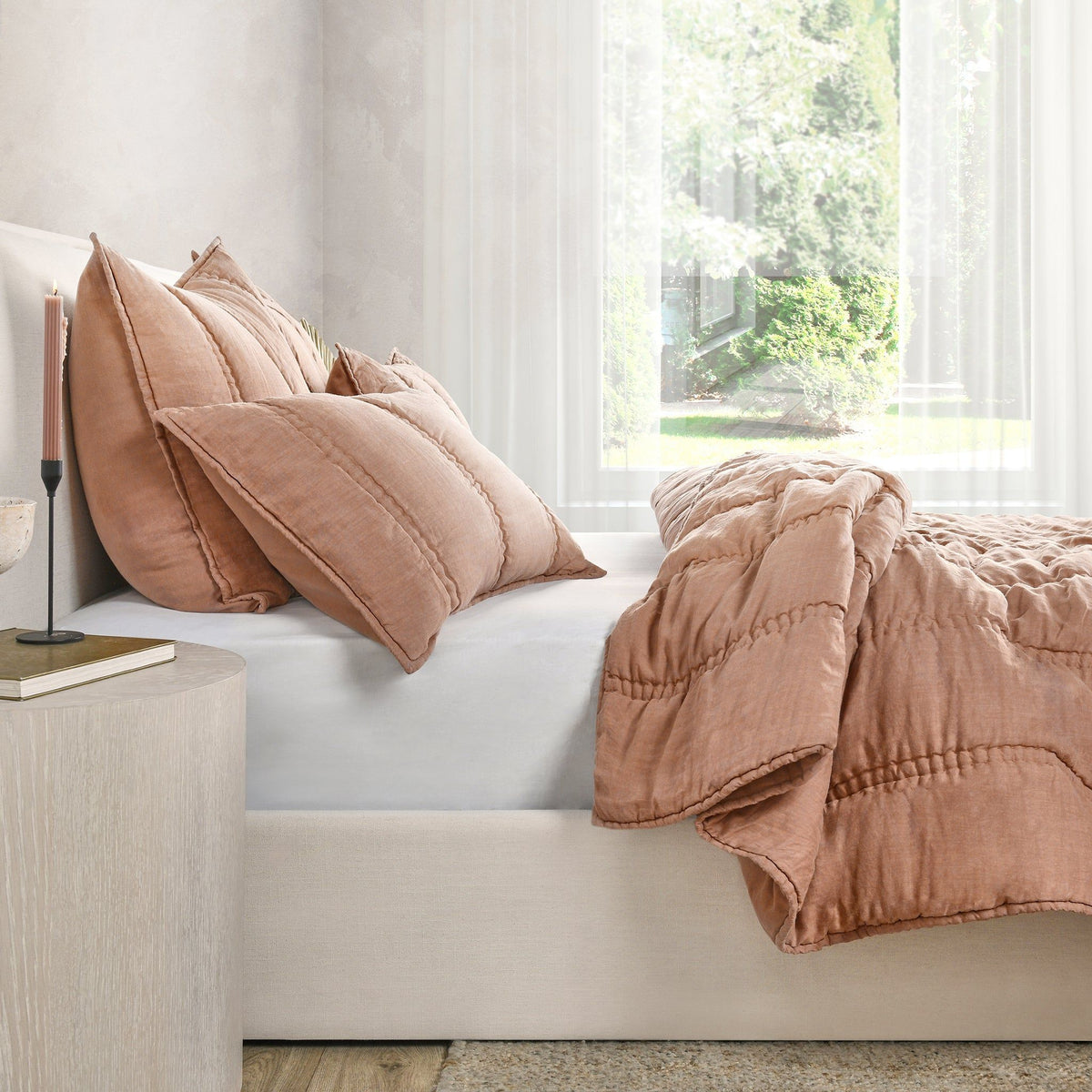 Clay quilt set with ruched channel stitching and coordinating pillow shams on bed