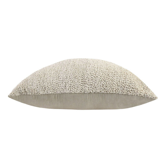 Beige floor cushion with rounded shape and textured boucle cover