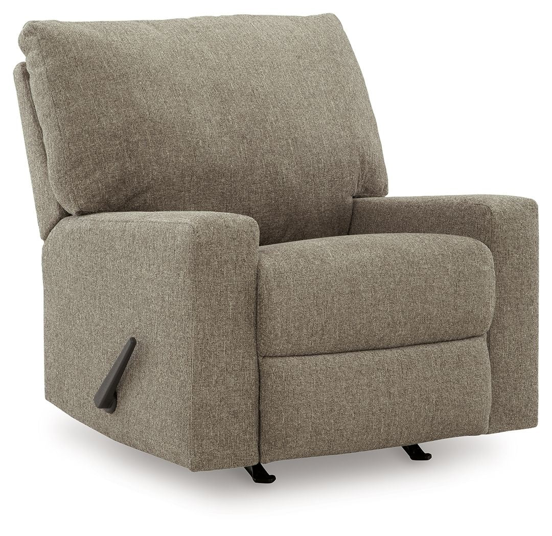Beige fabric rocker recliner with side control handle and padded armrests