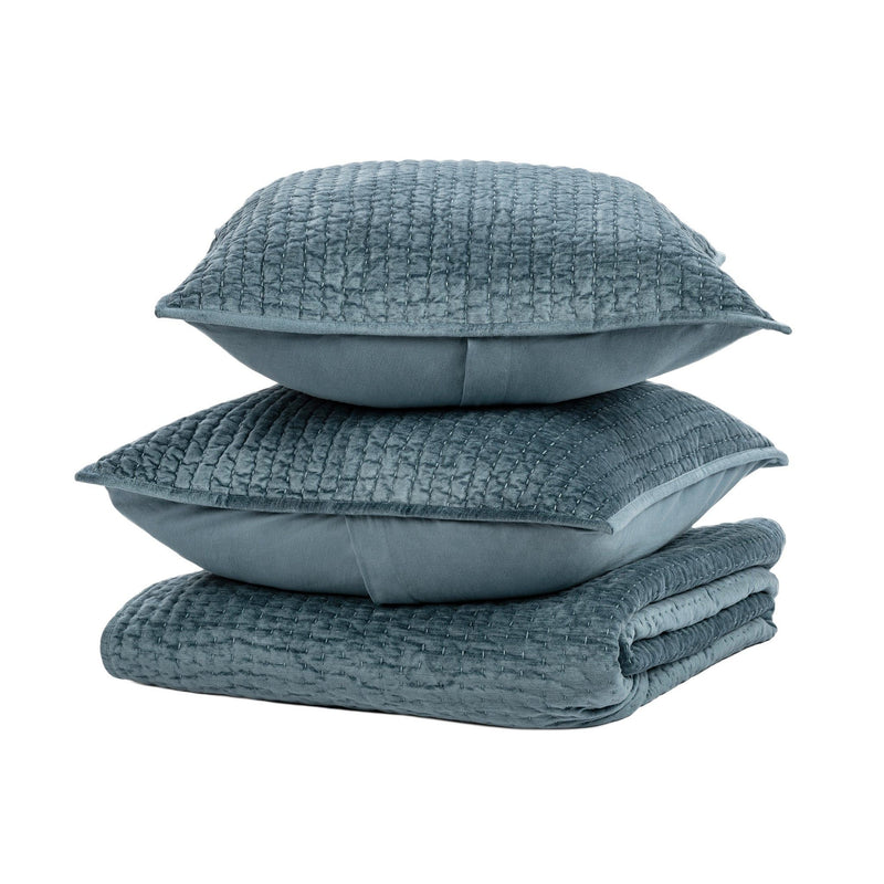 Blue velvet quilt set with coordinating shams and pillows